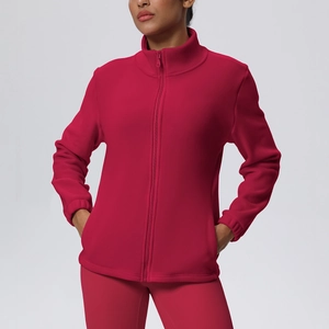 Detail of red fleece sports jacket with high collar zipper and warm lining texture