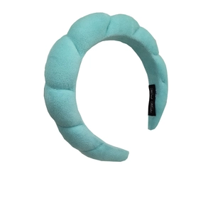 Close-up of Tiffany blue velvet padded headband showing soft texture and handmade label
