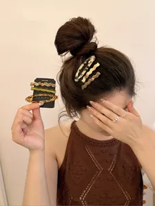 Close-up of tortoise shell acetate hair clips set worn by a model in a natural setting