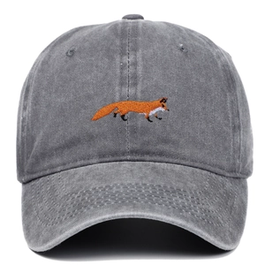 Detailed view of orange fox embroidery on a dark grey washed cotton baseball cap