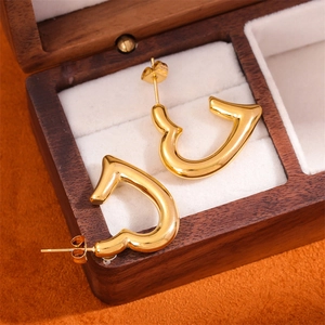 Artistic 18K gold plated stainless steel heart stud earrings on luxury jewelry box