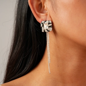 Elegant geometric square earrings with sparkling rhinestone tassels worn by a model