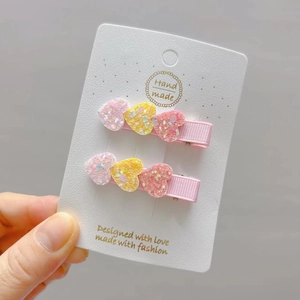 Two-piece set of glitter heart hair clips for girls featuring pink ribbon ducksbill clips