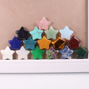 Macro shot of 16 colorful star-shaped semi-precious stones stacked in a pyramid layout