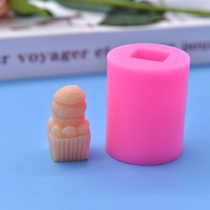 Close-up of pink silicone snowman hat mold with textured DIY candle and dessert finish