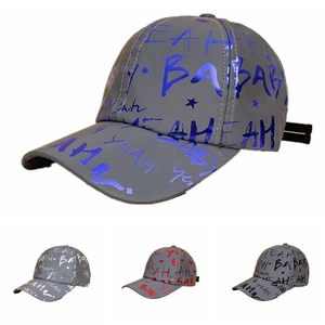Close-up of baseball caps featuring all-over graffiti prints and colorful foil patterns