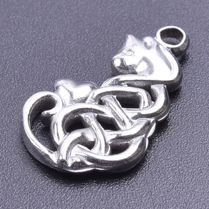 Macro shot of silver cat pendant with intricate Celtic knot patterns on dark background