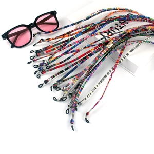 Close-up of colorful Bohemian woven eyewear straps with anti-slip rubber loops and metal rings