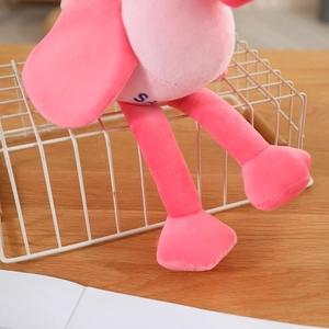 Detail of soft pink plush flamingo legs showing high-quality short plush fabric texture