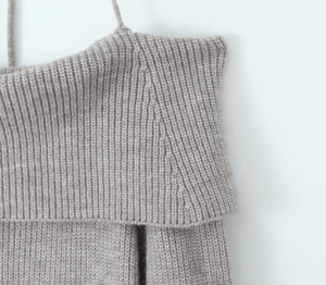 Detail of ribbed knit off-shoulder top in oatmeal color with thin straps and folded collar
