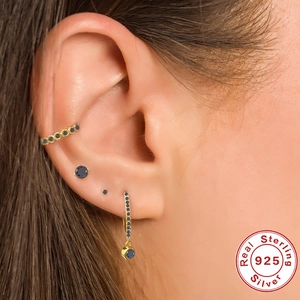 Close-up of four-piece 925 sterling silver ear set with black stones on a model's ear