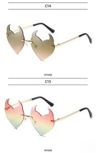 Detail view of heart-shaped devil horn rimless sunglasses in C14 and C15 color gradients