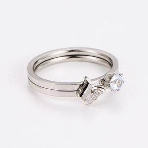 Close-up of silver butterfly ring set with matte texture and sparkling zircon stone