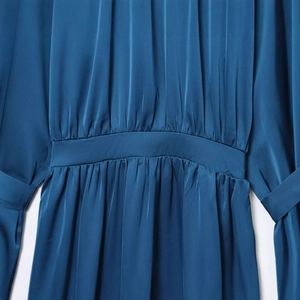 Navy blue high-neck satin midi dress featuring elegant waist pleats and shiny silk texture