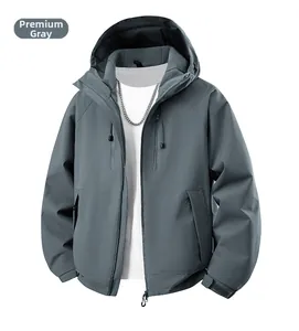 Détail du coupe-vent à capuche gris avec poignets réglables et poches zippées sur la poitrine