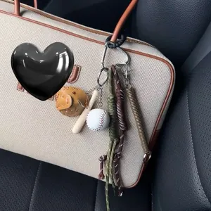 Detailed mini baseball keychain set with glove and bat hanging on a canvas tote bag