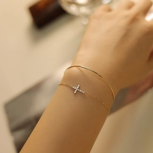 Elegant 18K gold plated S925 silver cross bracelet with zircons and thin bangle on wrist