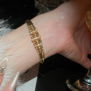 Detail showing 18k gold plated hollow zircon bangle with sparkling gemstone inlay
