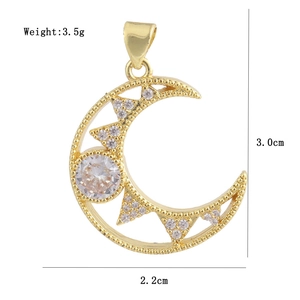 Macro shot of gold crescent moon pendant with white zircon and dimension labels