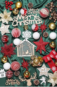 Flat lay of festive Christmas tree ornaments with red stars, gold baubles and pine cones