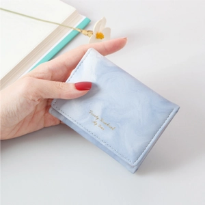 Slim tri-fold mini wallet in light blue marble pattern with gold lettering and PU leather