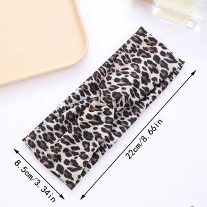 Leopard print headband displayed with dimensions 22cm by 8.5cm on a white background