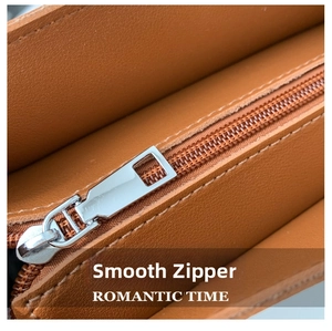 Macro view of smooth silver metal zipper and fine stitching on the brown leather bag