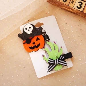 Detail of Halloween hair clips with glitter pumpkin and zombie hand on white card