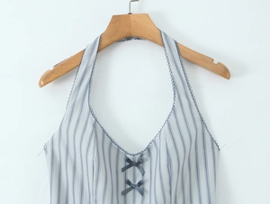 Detail of blue striped dress featuring a navy bow and delicate lace trim on neckline