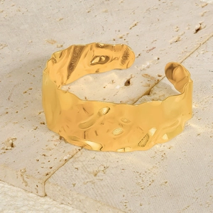Detail of 18k gold plated stainless steel cuff with unique hammered texture on stone