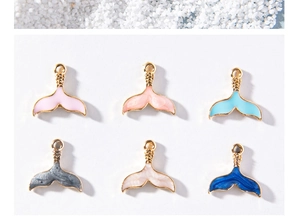 Detail showing six colorful enamel mermaid tail charms for DIY jewelry making and crafts