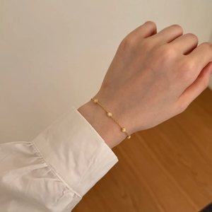 Close-up of S925 silver bracelet with white opal stones worn on a woman's wrist