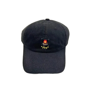 Close-up of black cotton baseball cap featuring fire patch with red flames and yellow embroidery