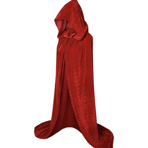 Macro detail of red velvet hooded cloak fabric with glossy finish and ribbon tie closure
