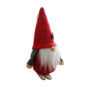 Nordic Christmas gnome plush figure with red hat and wooden skis on white background