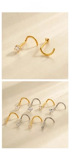 Macro shot of G23 titanium S-shape nose studs with sparkling cubic zirconia in gold and silver