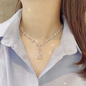 Elegant silver Y-shaped necklace with sparkling square crystals on a female model