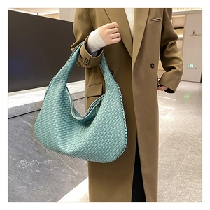 Detail of teal woven hobo bag showing the intricate texture and craftsmanship