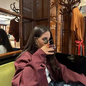 Vintage wine red zipper jacket and matching shorts set for women in a cafe setting
