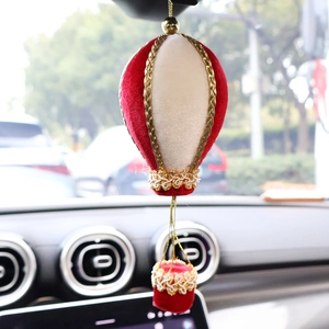 Velvet hot air balloon Christmas tree ornament hanging on a car rearview mirror