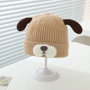 Detailed close-up of a rib-knit baby hat with cute 3D puppy ears and soft muzzle design