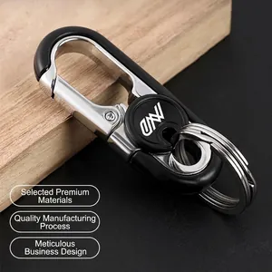 Business style zinc alloy car keychain with dual rings and spring buckle on wooden surface