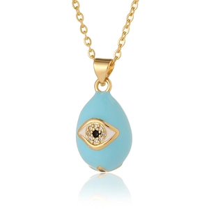 Close-up of gold drop necklace with blue enamel evil eye pendant and zircon stones