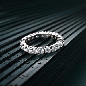 Macro shot of silver eternity ring with round-cut sparkling cubic zirconia stones
