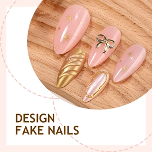Almond fake nails with champagne gold star patterns and 3D bow accents
