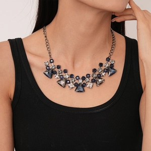 Close-up of geometric triangle crystal necklace with dark blue and grey rhinestones