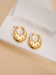 Macro shot of gold crescent moon earrings with vintage textured finish on stone