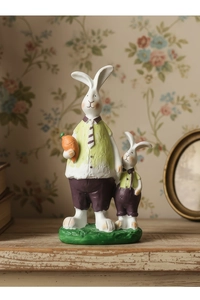 Detail of resin rabbit figurines in garden attire on a vintage wood shelf