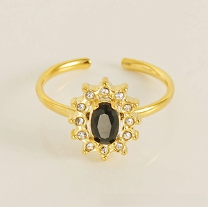 Macro shot of 18K gold plated sunflower ring featuring a black oval gem and white zircons