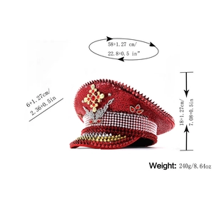 Detailed view of a red sequin captain hat with golden cross and silver studs